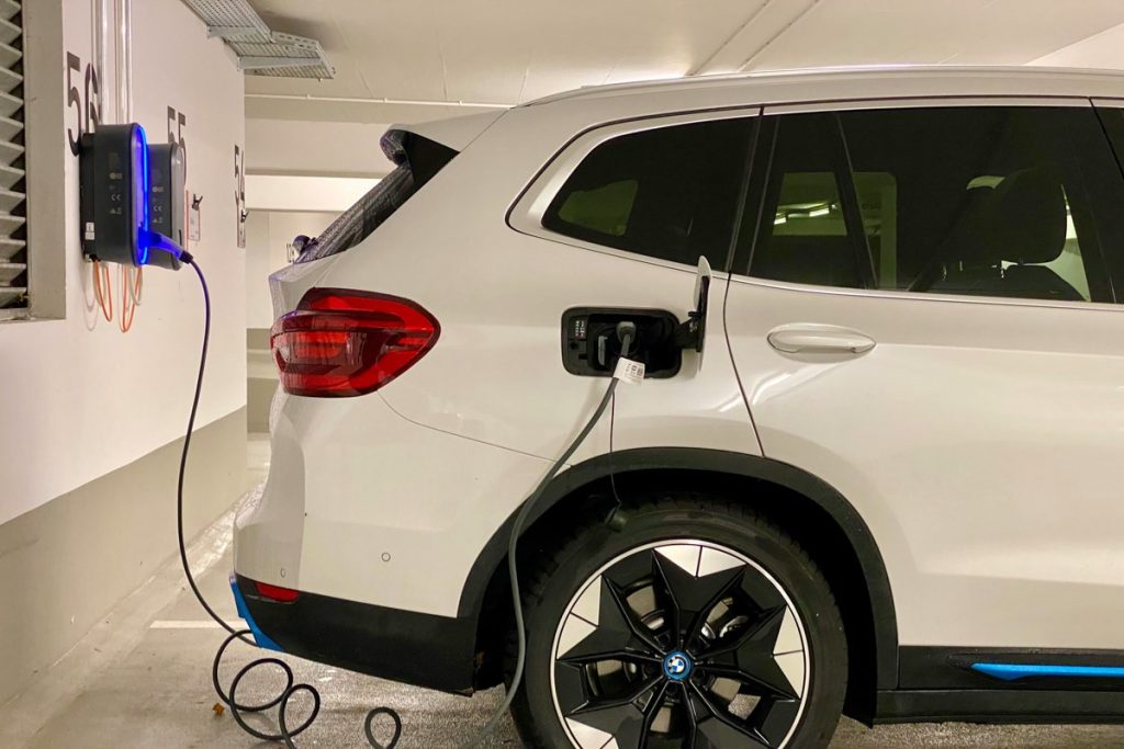 A BMW electric vehicle at a charging station.
