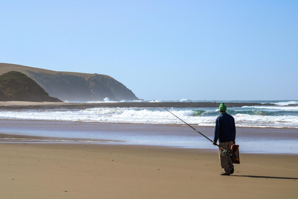 A fisherman walks along the beach at Dwesa Nature Reserve.