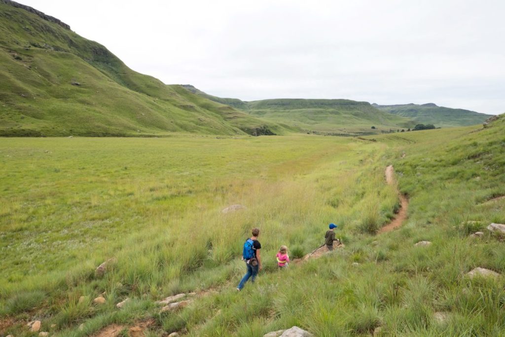 A family walks through the Drakensberg.